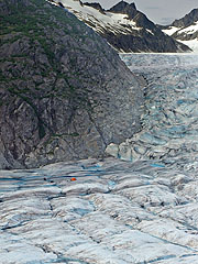 Tiny people and helicopter on the huge glacier