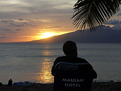 A Mauian Hotel guest watches the Napili sunset