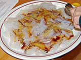 Dressing cooked noodles with soy sauce, sesame oil