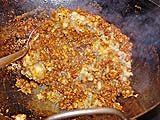 Mixing mashed eggplant into chilli paste and pork