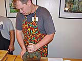 Crushing chillies with galanga for chicken salad