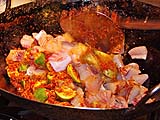 Frying chunks of sturgeon in chilli paste