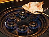 Drying salted dried squid (sub for cuttlefish) over flame