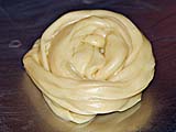Stretched roti dough formed into a snail-like swirl