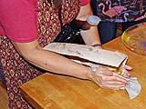 Fluffing the plain roti (in an absorbent towel)