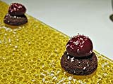 Tiny chocolate cake with a raspberry sauce balloon